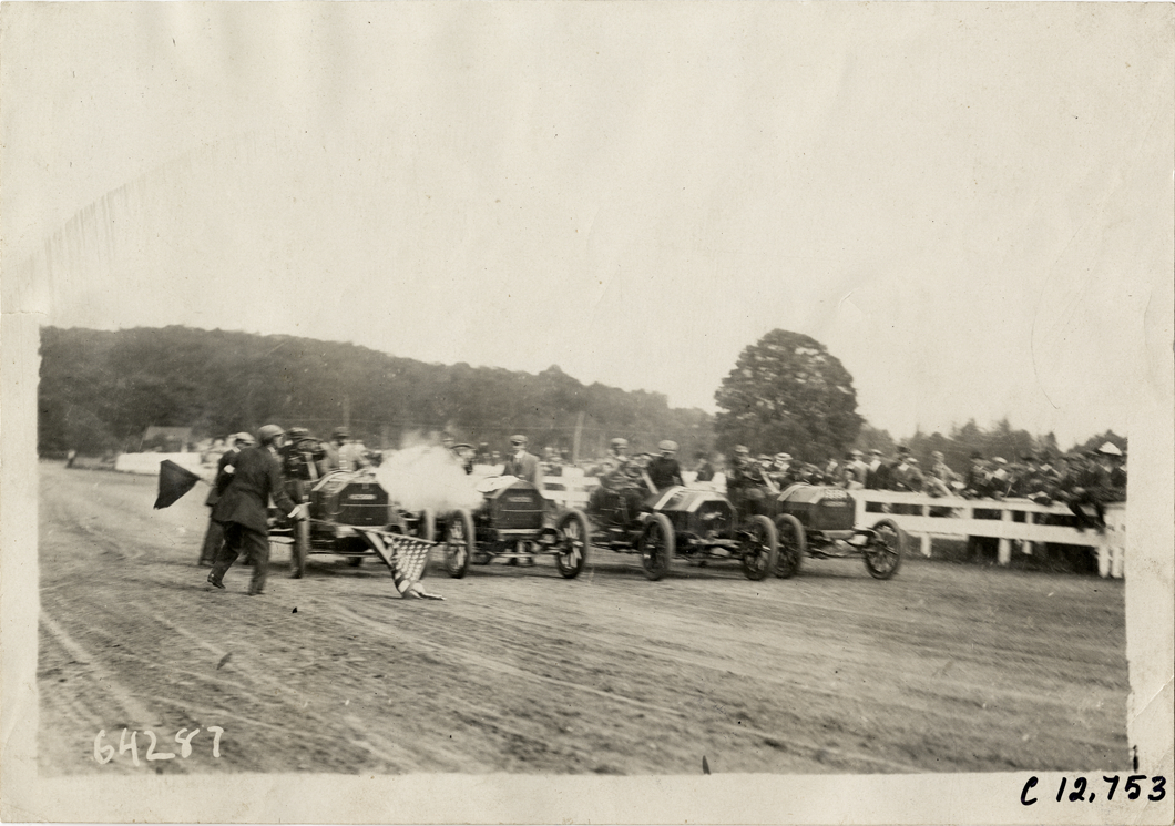 Racecars lined up on track, 1910 Empire City races