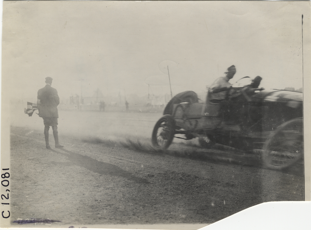 Racecar crossing finish line, 1911 Brighton Beach races