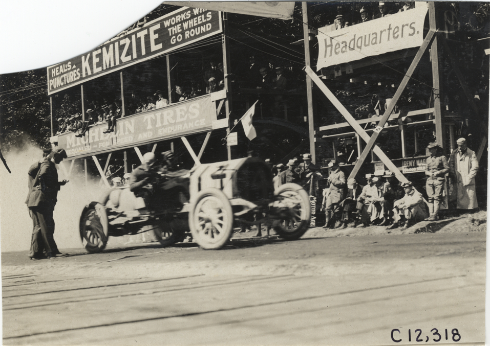 Racecar parked in front of spectators in stands, 1909 Crown Point races