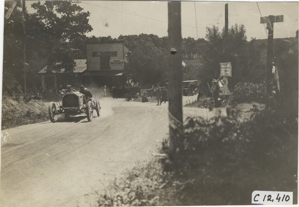 Driver and passenger in racecar, 1909 Crown Point races