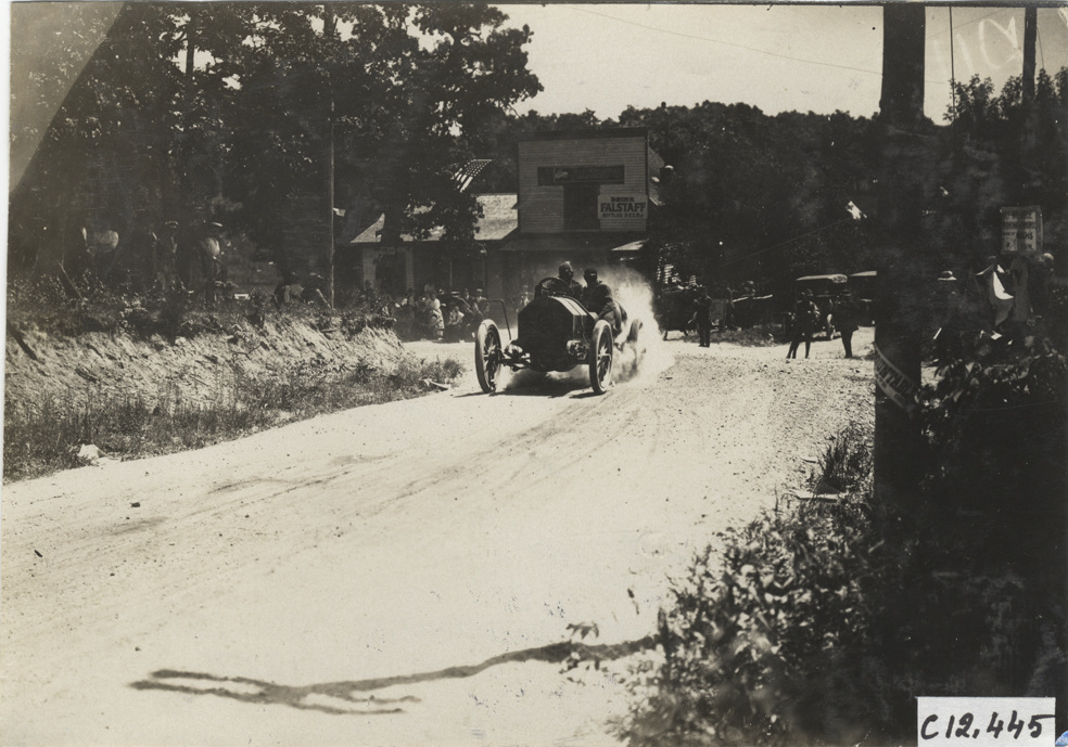 Driver and passenger in racecar, 1909 Crown Point races