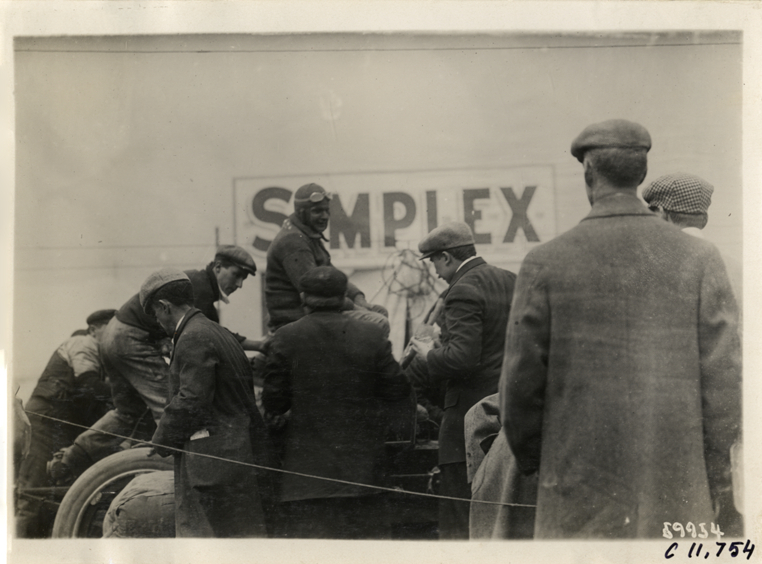 Men working on Simplex racecar, 1909 Brighton Beach races