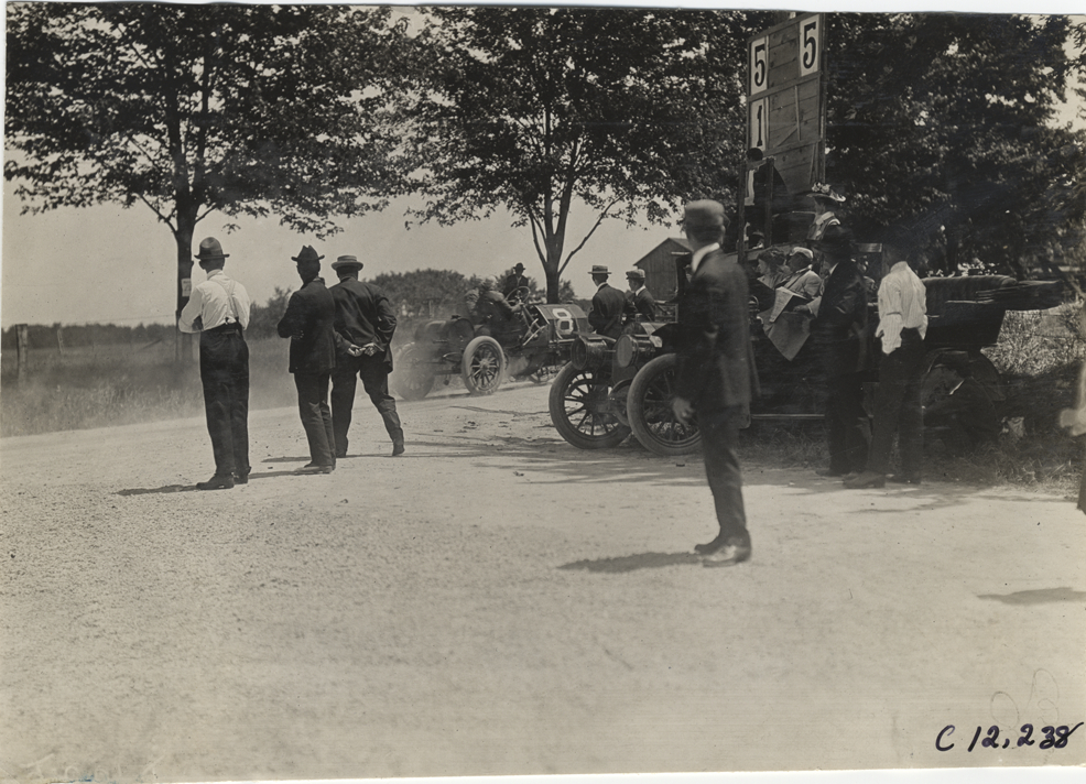 Spectators watching racecar, 1909 Crown Point races