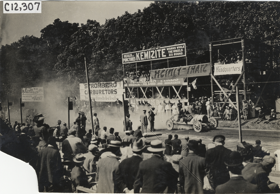 Racecar parked in front of spectators in stands, 1909 Crown Point races