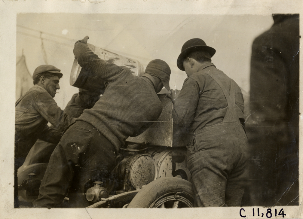 Men fueling racecar, 1909 Brighton Beach races