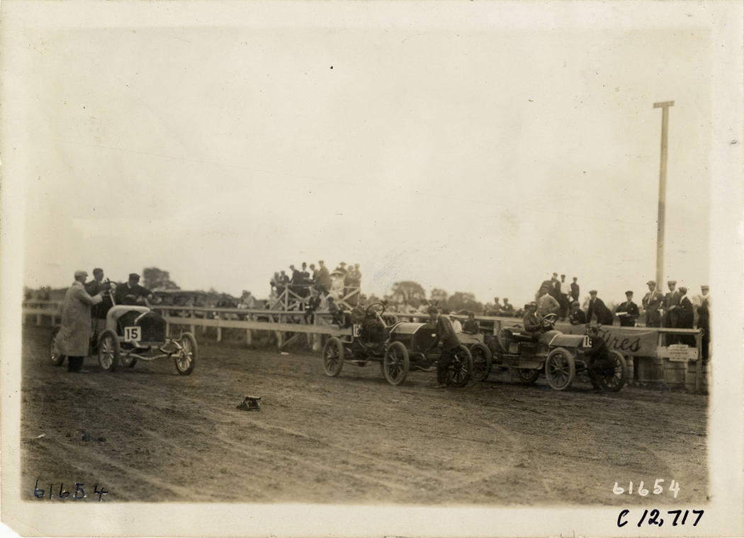Racecars lined up on track, 1910 Empire City races