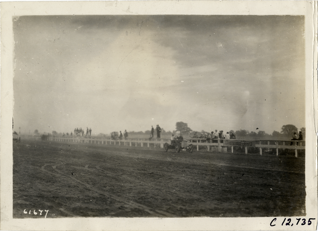 Driver and passenger in racecar, 1910 Empire City races