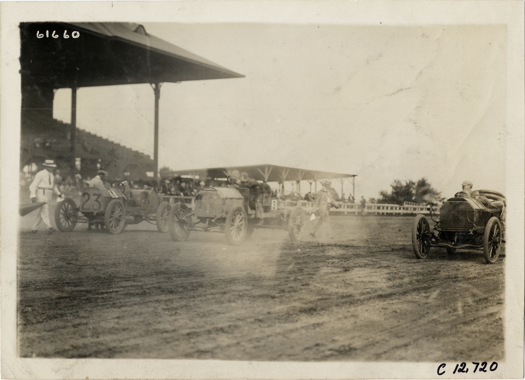 Racecars lined up on track, 1910 Empire City races
