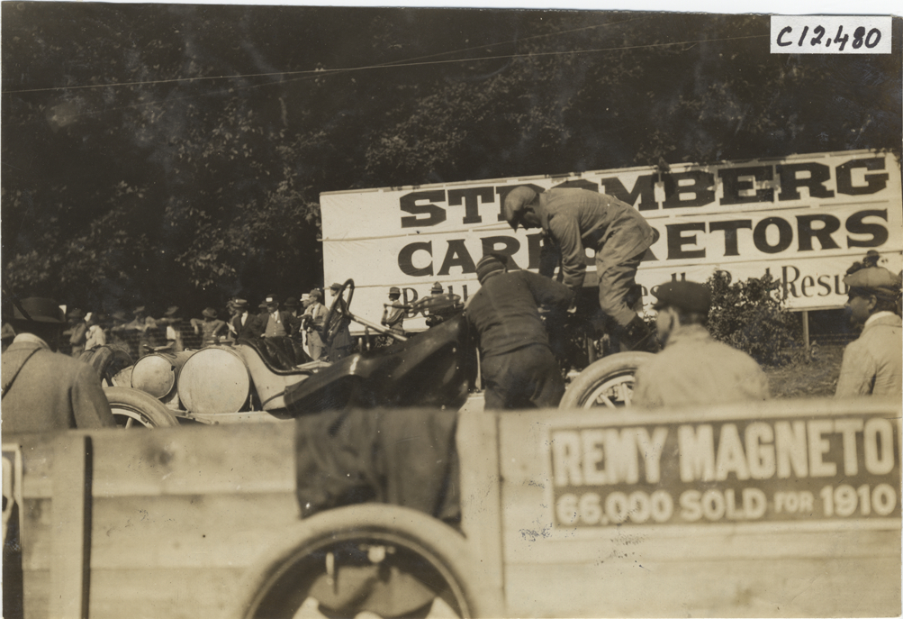 Two men working on racecar, 1909 Crown Point races