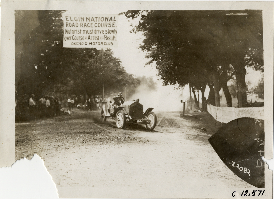 Driver and passenger in racecar, 1910 Elgin Races