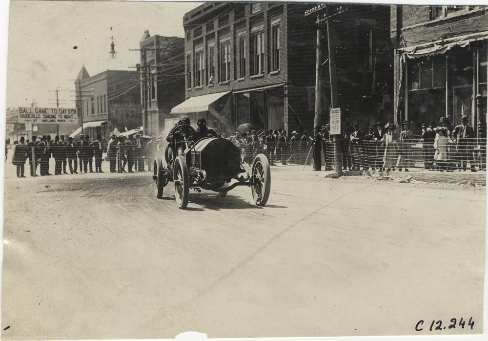 Driver and passenger in racecar, 1909 Crown Point races