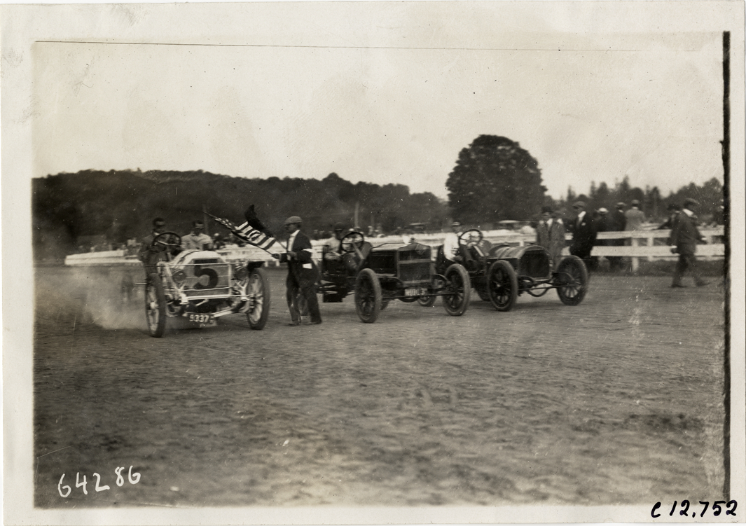Racecars lined up on track, 1910 Empire City races