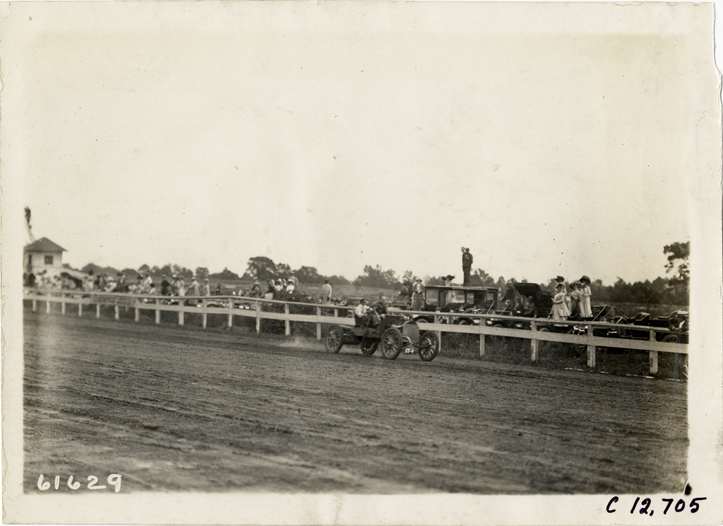 Driver and passenger in racecar, 1910 Empire City races