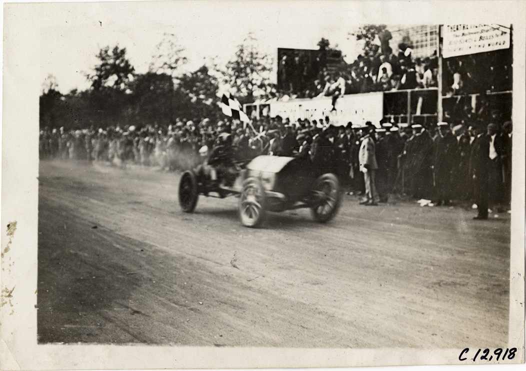 Racecar crossing finish line, 1909 Fairmount Park races
