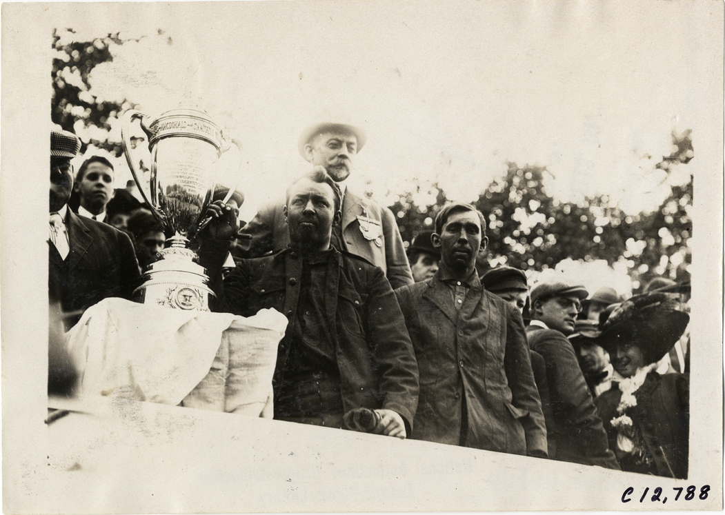 George Robertson posing with trophy cup, 1909 Fairmount Park races