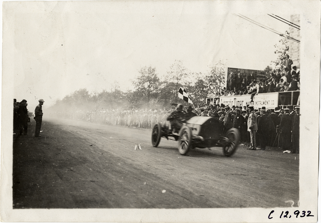 Racecar crossing finish line, 1909 Fairmount Park races