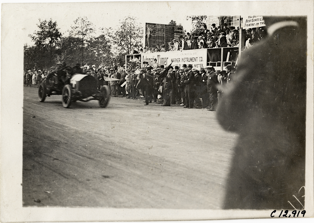 Racecar crossing finish line, 1909 Fairmount Park races