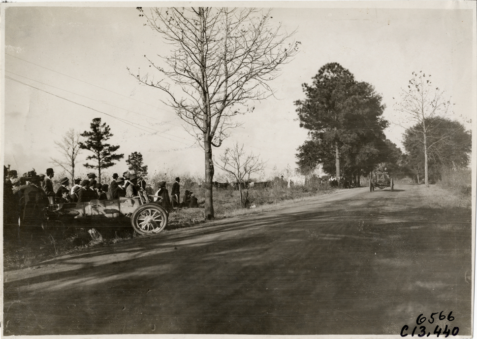 Driver and passenger in racecar, 1908 Grand Prize races