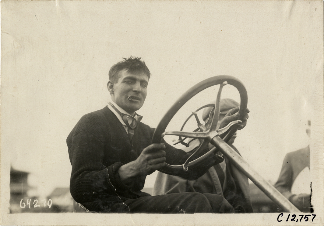Driver in racecar, 1910 Empire City races