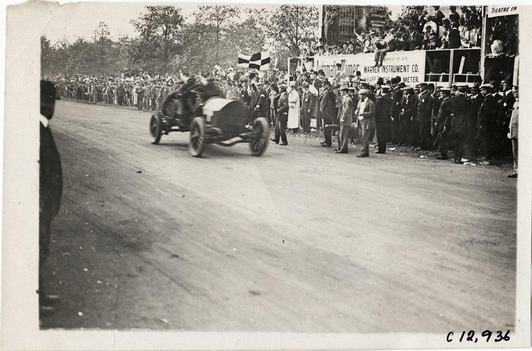 Racecar crossing finish line, 1909 Fairmount Park races