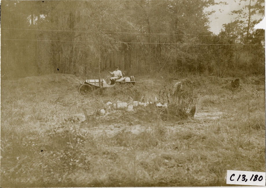 Motorist traveling past graves, 1908 Grand Prize races