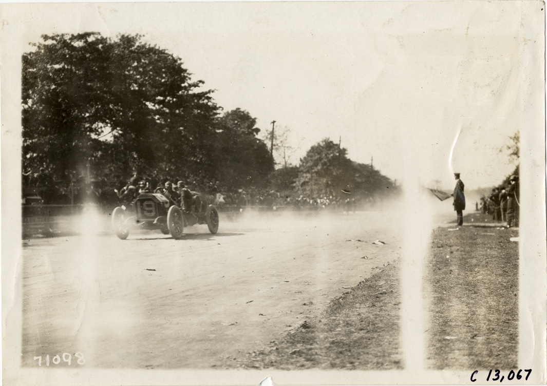 H.S. Matthews and passenger in Ohio racecar, 1911 Fairmount Park races