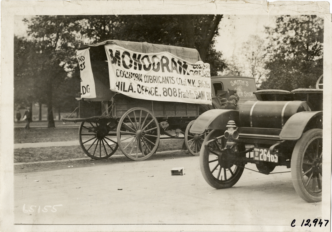 Horse-drawn wagon with Monogram oil banner, 1910 Fairmount Park races