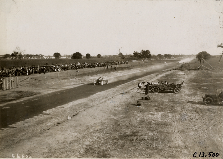 Driver and passenger in racecar, 1908 Grand Prize races