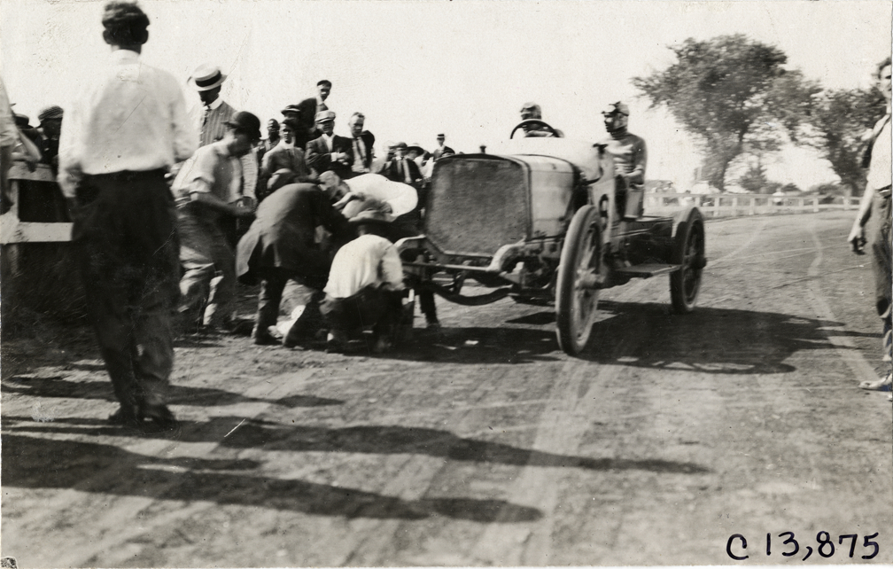 Driver and passenger in racecar, 1908 Long Branch races