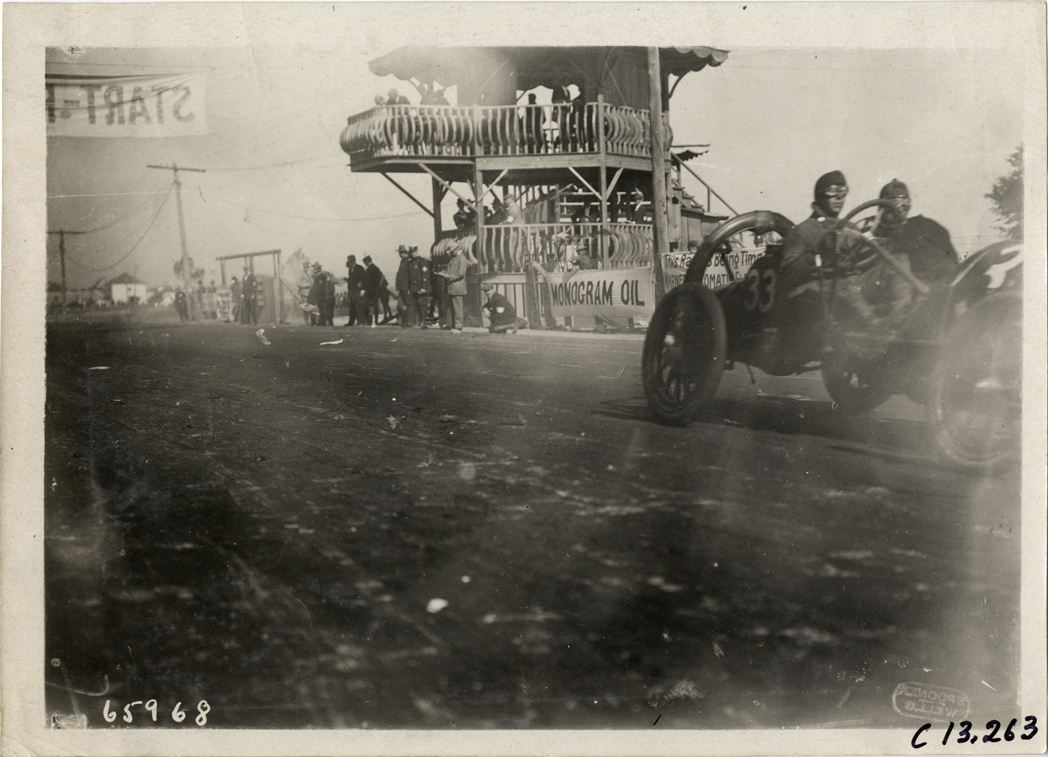 Racecar passing judges' stand, 1910 Grand Prize races