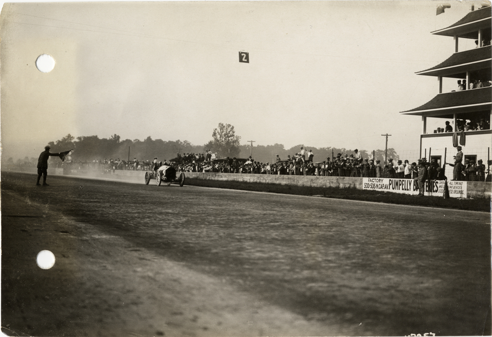 Stutz racecar crossing finish line, 1913 Indianapolis 500 automobile race