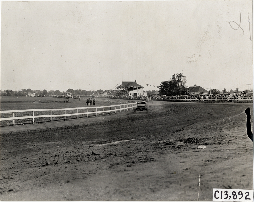 Driver and passenger in racecar, 1908 Long Branch races