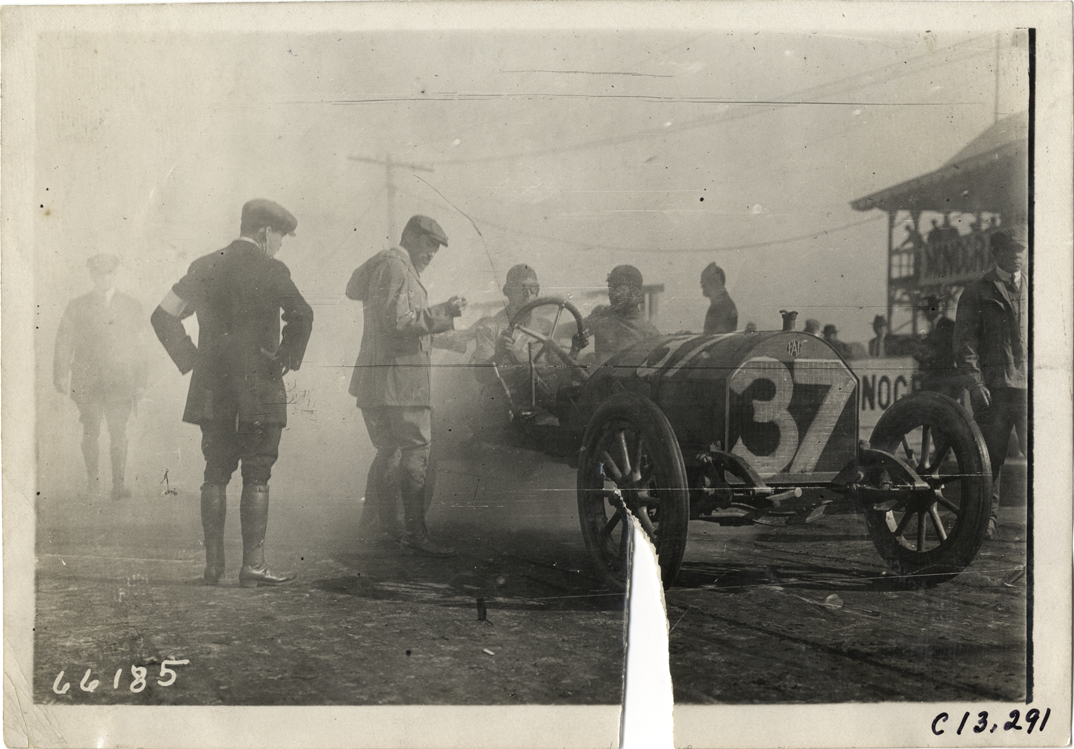 Driver and passenger in racecar, 1910 Grand Prize races
