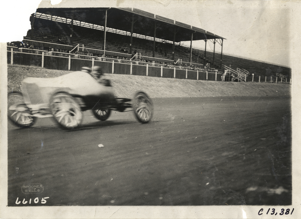 Racecar passing grandstand, 1910 Grand Prize races