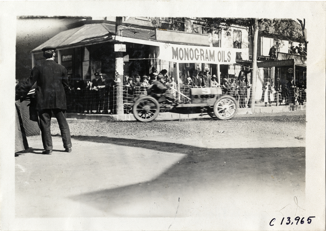 Driver and passenger in racecar, 1909 Long Island Derby