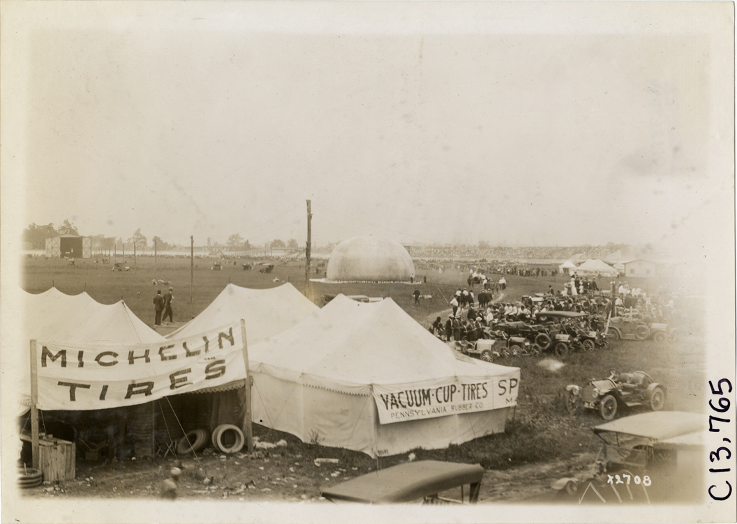 Hot air balloon in field, 1911 Indianapolis 500 automobile race
