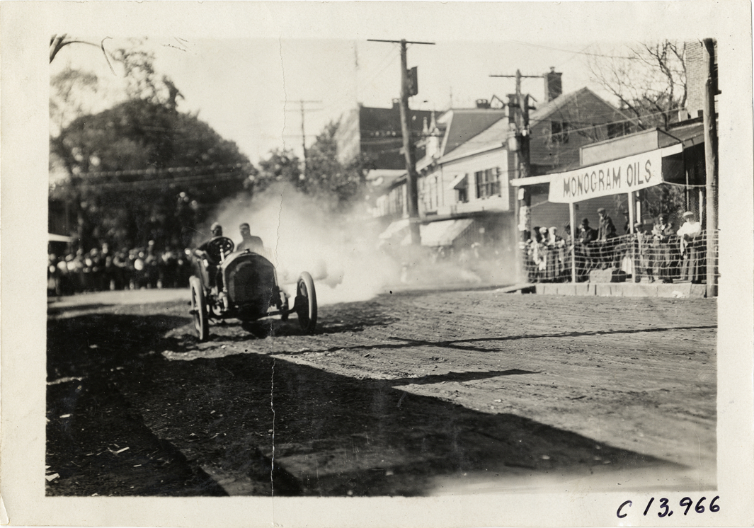 Driver and passenger in racecar, 1909 Long Island Derby