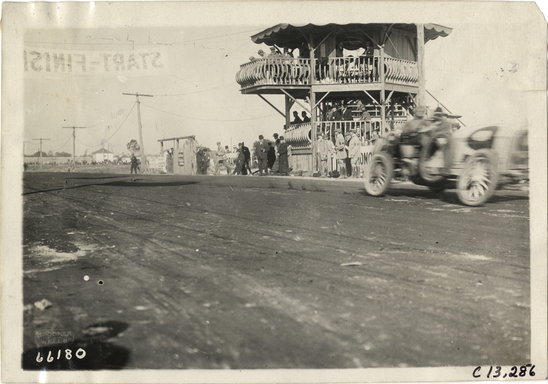 Racecar passing judges' stand, 1910 Grand Prize races