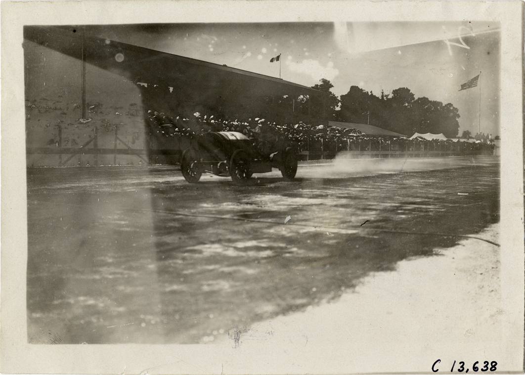Driver and passenger in racecar, 1909 Indianapolis races