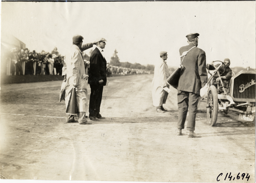 Officials standing next to Buick racecar, 1909 Readville races