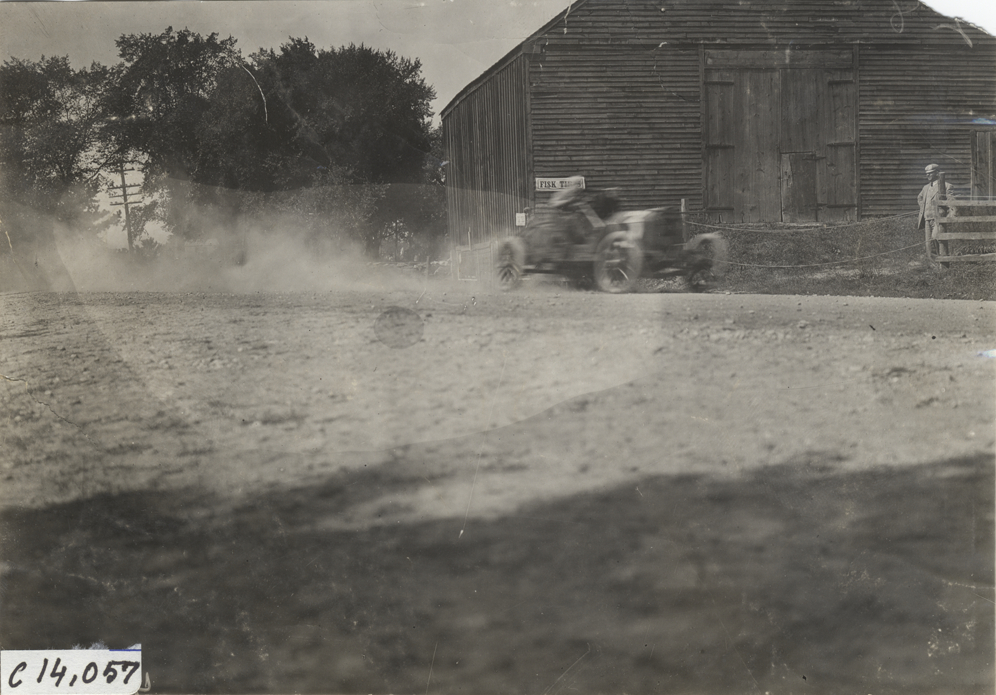 Racecar passing barn, 1908 Lowell road race