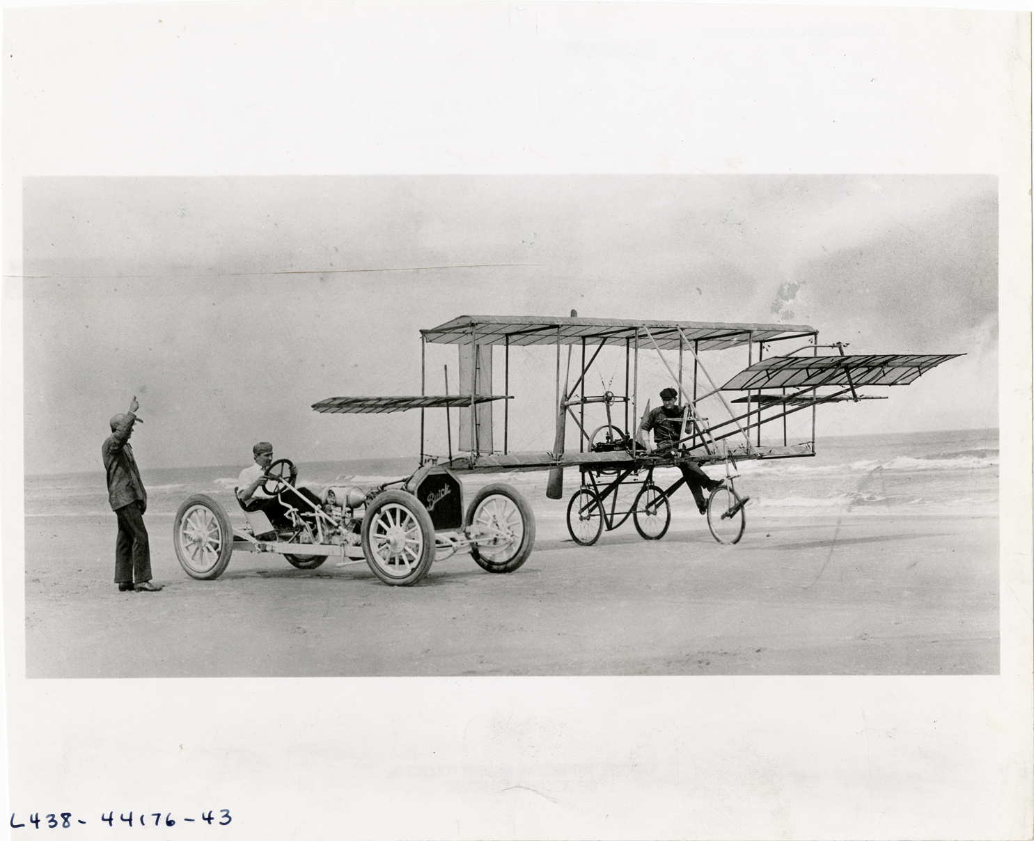 Carl S. Bates, Louis Strang and Bob Burman with biplane and Buick ...