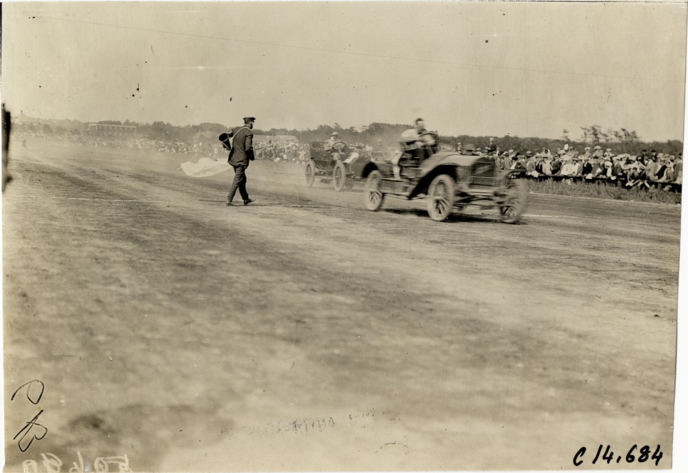 Racecars crossing finish line, 1909 Readville races