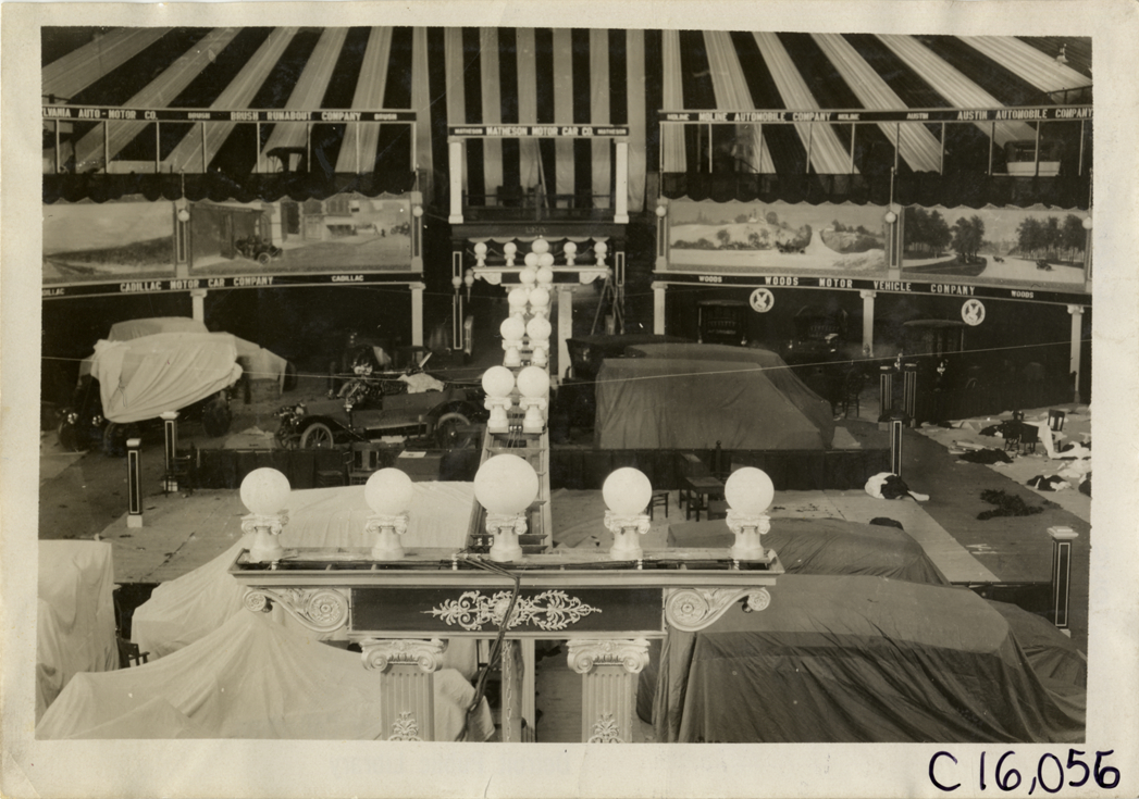 Automobiles in exhibit area during installation, 1909 Atlanta Auto Show