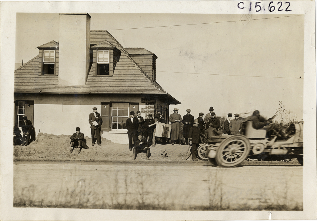 Racecar passing Meadow Brook toll lodge, 1909 Vanderbilt Cup races