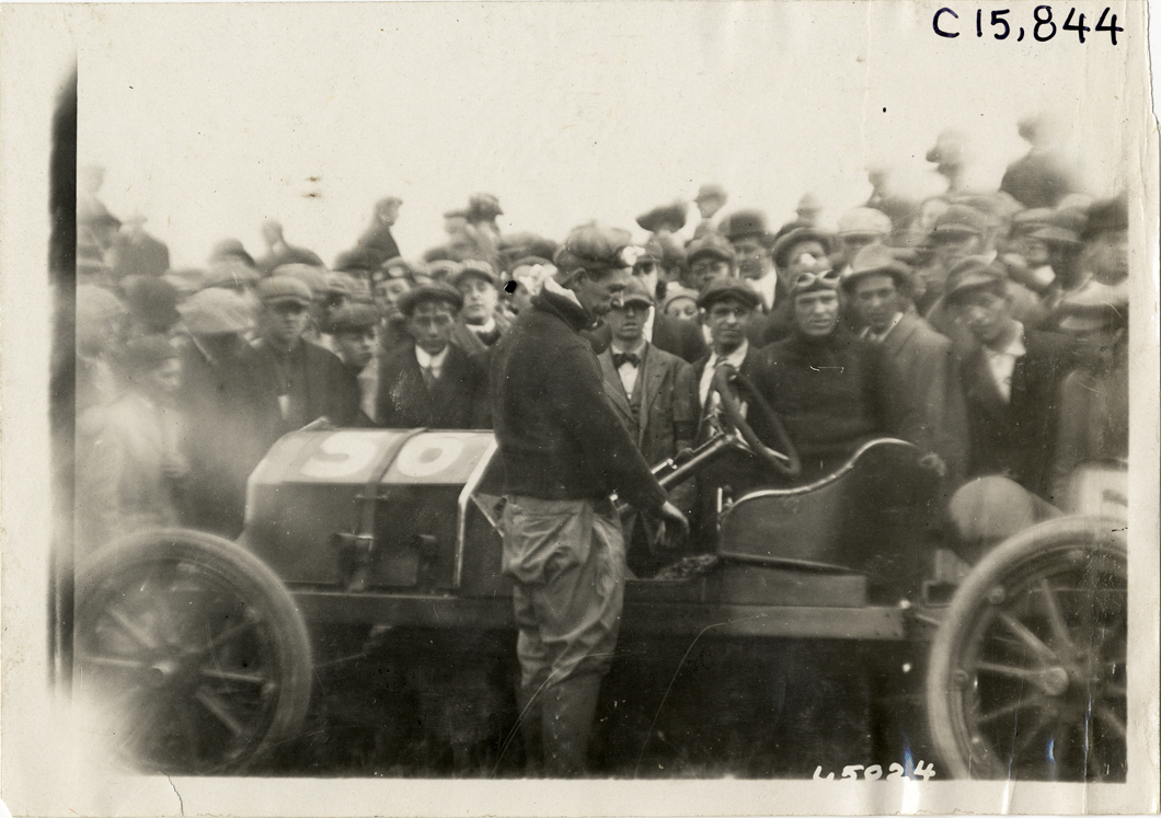 Driver standing next to racecar, 1910 Vanderbilt Cup races