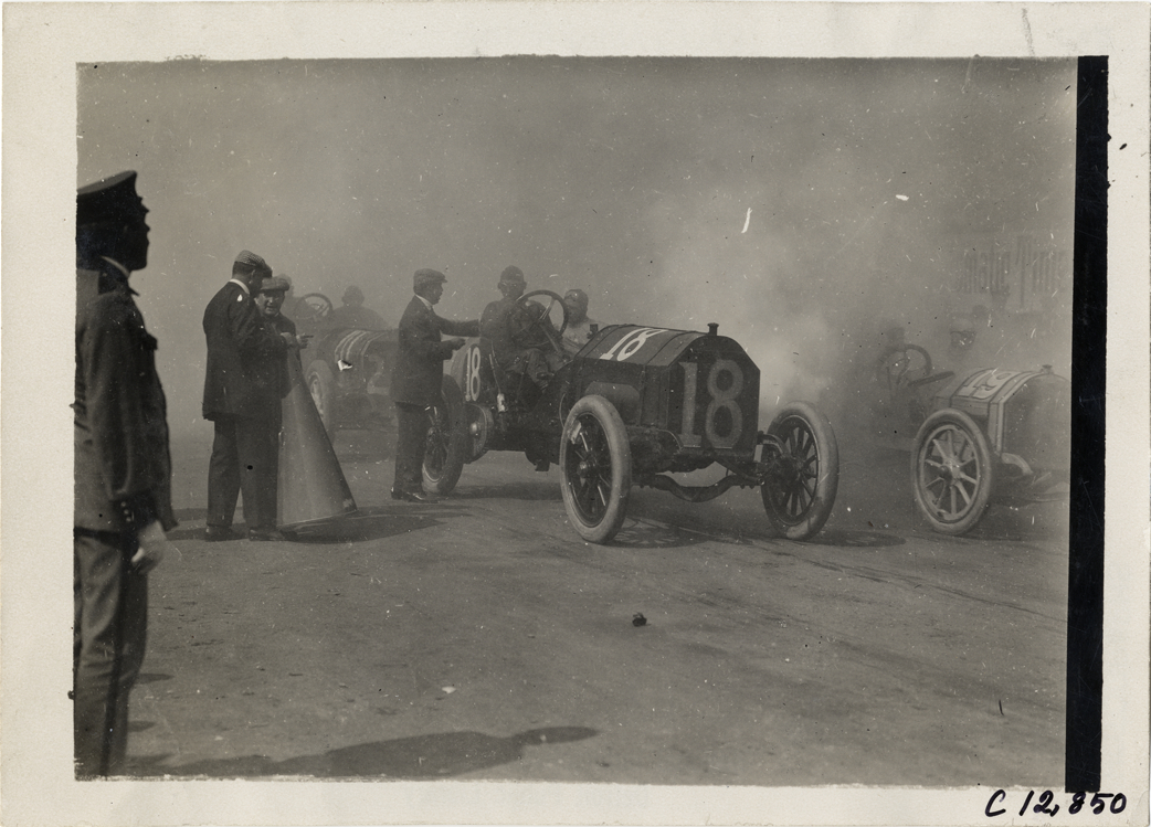 Officials with racecar, 1909 Fairmount Park races