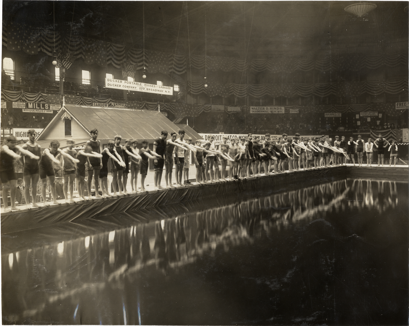 Swimmers preparing to dive into pool, 1909 Sportsman's Show
