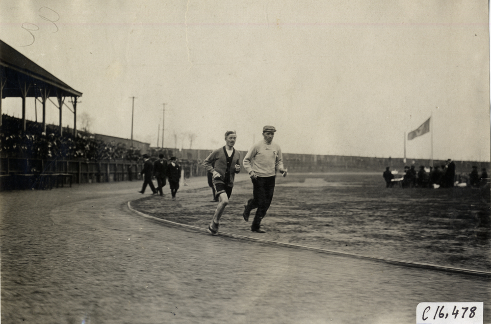Runner and official running on track