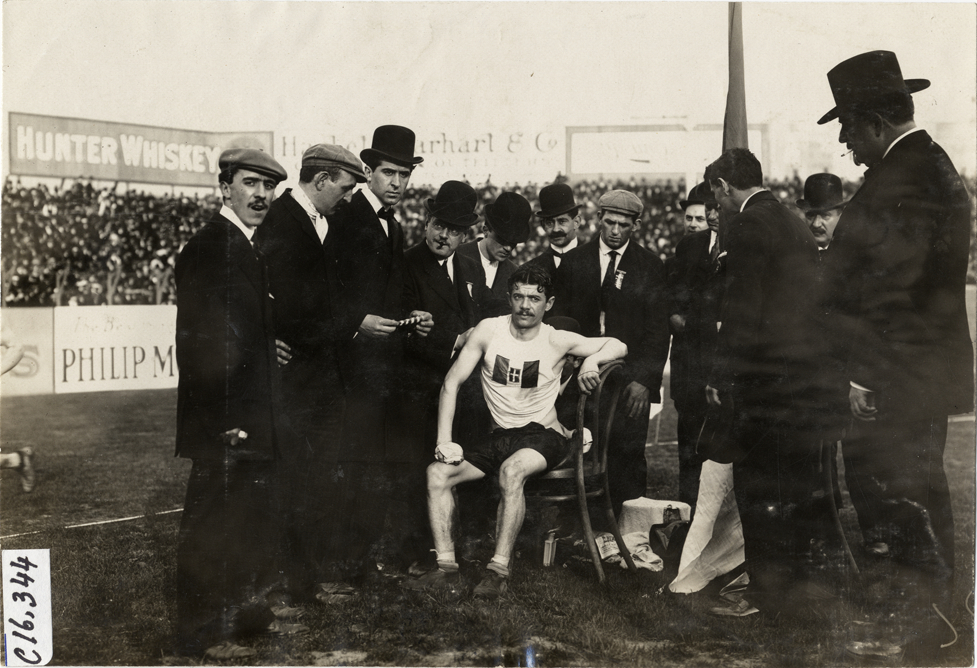 Runners and officials at track meet